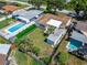 Aerial view of a property with a spacious backyard, swimming pool and lush greenery at 6554 34Th N Ave, St Petersburg, FL 33710