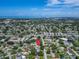 High-angle aerial view of a residential area leading to a coastal landscape, pinpointed by a bright red locator at 6554 34Th N Ave, St Petersburg, FL 33710