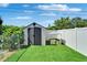A tidy backyard shed with a seating area; fenced for privacy and freshly manicured at 6554 34Th N Ave, St Petersburg, FL 33710