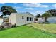 Backyard featuring a well-manicured lawn, fenced yard, storage shed, and lush landscaping at 6554 34Th N Ave, St Petersburg, FL 33710