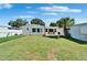 Backyard featuring a well-manicured lawn, patio area, storage shed, and fenced perimeter at 6554 34Th N Ave, St Petersburg, FL 33710