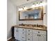 Bathroom featuring granite vanity, warm-toned wood trim, and modern lighting fixtures at 6554 34Th N Ave, St Petersburg, FL 33710