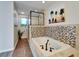 Relaxing bathroom featuring a spa tub with decorative tile, frameless shower, and natural light at 6554 34Th N Ave, St Petersburg, FL 33710