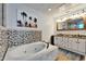 A jacuzzi bathtub is centered in a Primary bathroom with dual vanity and warm neutral tones at 6554 34Th N Ave, St Petersburg, FL 33710