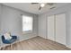 Bedroom with wood-look floors, white trim, a window, and double door closet at 6554 34Th N Ave, St Petersburg, FL 33710