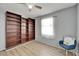 Cozy bedroom with a built-in bookcase, wood-look floors, and natural light at 6554 34Th N Ave, St Petersburg, FL 33710