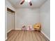 Bedroom features wood-look flooring, closet, and seating area with cute animal paintings at 6554 34Th N Ave, St Petersburg, FL 33710