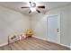 Cozy room with a ceiling fan, wood-look flooring, and a bright yellow chair at 6554 34Th N Ave, St Petersburg, FL 33710