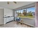 Bright bedroom featuring updated flooring, large window views, and vintage dresser at 6554 34Th N Ave, St Petersburg, FL 33710