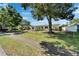 View of cute home with mature shade trees and fenced-in front yard at 6554 34Th N Ave, St Petersburg, FL 33710