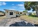 Cozy house featuring fenced front yard, shade trees, and a boat at 6554 34Th N Ave, St Petersburg, FL 33710