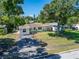 A lovely single-story house with mature trees providing shade and curb appeal at 6554 34Th N Ave, St Petersburg, FL 33710