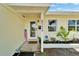 Inviting front porch with welcome decorations and house number for a cheerful entry at 6554 34Th N Ave, St Petersburg, FL 33710