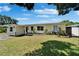 Charming single-story home featuring a well-maintained lawn, bright facade, and clear windows at 6554 34Th N Ave, St Petersburg, FL 33710