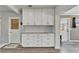 Clean, modern kitchen with white cabinetry, stone countertops, backsplash, and modern flooring at 6554 34Th N Ave, St Petersburg, FL 33710