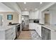 Modern kitchen boasts stainless steel appliances, granite countertops, and seamlessly blends into the living room at 6554 34Th N Ave, St Petersburg, FL 33710