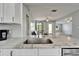 Beautiful kitchen featuring granite countertops, stainless steel sink, and open view to the living areas at 6554 34Th N Ave, St Petersburg, FL 33710