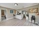 Open concept kitchen with counter seating, a view into the dining and living room, and white cabinets at 6554 34Th N Ave, St Petersburg, FL 33710