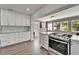 Bright kitchen showcasing stainless steel appliances, white cabinets, stone countertops, and modern flooring at 6554 34Th N Ave, St Petersburg, FL 33710