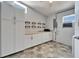 Functional laundry room features ample cabinetry, countertops, and shelving for storage at 6554 34Th N Ave, St Petersburg, FL 33710