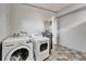 Large laundry room featuring modern washer and dryer set, water heater, and tile floors at 6554 34Th N Ave, St Petersburg, FL 33710