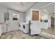 Bright laundry room includes washer, dryer, utility sink, and view of kitchen at 6554 34Th N Ave, St Petersburg, FL 33710