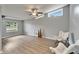 Bright living room featuring wood-look flooring, stylish chairs, and ample natural light from multiple windows at 6554 34Th N Ave, St Petersburg, FL 33710