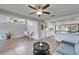 Open living room with modern furnishings, ceiling fan, and seamless access to the updated kitchen at 6554 34Th N Ave, St Petersburg, FL 33710
