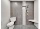 Modern bathroom shower with gray tiling, built-in seat, and convenient niche at 6554 34Th N Ave, St Petersburg, FL 33710