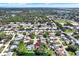 Picturesque aerial view of a residential community near a lake and a recreational field at 6561 Exeter Ct, Seminole, FL 33772