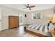 Comfortable bedroom with tile floors, ceiling fan, and a private door leading to the outside at 6561 Exeter Ct, Seminole, FL 33772
