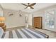 Bright bedroom with tile floors, a ceiling fan, and a door to the outside at 6561 Exeter Ct, Seminole, FL 33772