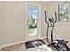 Bright exercise room with an elliptical machine and a door to the outside at 6561 Exeter Ct, Seminole, FL 33772