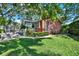 Charming home with brick accents, screened porch, and lush green lawn, perfect for outdoor living at 6561 Exeter Ct, Seminole, FL 33772