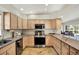Modern kitchen with stainless steel appliances, granite countertops, and ample cabinet space at 6561 Exeter Ct, Seminole, FL 33772