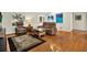 Warm and inviting living room with hardwood floors, a recliner sofa set, and a decorative area rug at 6561 Exeter Ct, Seminole, FL 33772