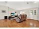 Cozy living room with hardwood floors, a recliner sofa, and plenty of natural light at 6561 Exeter Ct, Seminole, FL 33772