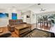 Spacious living room with hardwood floors, comfortable sofa seating, and a view of the dining area at 6561 Exeter Ct, Seminole, FL 33772