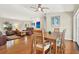 Bright and airy open-concept living and dining area with hardwood floors and a ceiling fan at 6561 Exeter Ct, Seminole, FL 33772