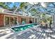 Inviting backyard with a screened-in pool and outdoor dining, ideal for enjoying the outdoors at 6561 Exeter Ct, Seminole, FL 33772