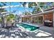 Backyard pool area with outdoor dining and lounge space, perfect for entertaining guests at 6561 Exeter Ct, Seminole, FL 33772
