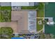 Aerial view of a home with a well-maintained roof, long driveway, and boat dock at 735 123Rd Ave, Treasure Island, FL 33706