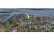Aerial view showing waterfront property with boat access and nearby community at 735 123Rd Ave, Treasure Island, FL 33706