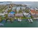 Aerial view of waterfront homes with private docks, offering a picturesque coastal living experience at 735 123Rd Ave, Treasure Island, FL 33706