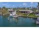 Waterfront home with a private dock, boat, and lush landscaping, offering serene water views at 735 123Rd Ave, Treasure Island, FL 33706