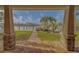 Inviting backyard view from the covered patio, featuring a stone walkway leading to the boat dock and waterfront at 735 123Rd Ave, Treasure Island, FL 33706