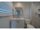 Bathroom featuring a white vanity, modern faucet and mirror, and a tiled shower at 735 123Rd Ave, Treasure Island, FL 33706
