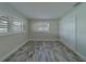 Bedroom featuring shuttered windows, a closet, and light wood flooring at 735 123Rd Ave, Treasure Island, FL 33706