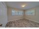 This bedroom features wood-look flooring, neutral walls, a closet and shuttered windows at 735 123Rd Ave, Treasure Island, FL 33706