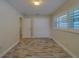 This is a bright bedroom with wood look floors, shuttered windows and a closet at 735 123Rd Ave, Treasure Island, FL 33706